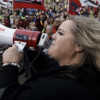 Looking strong and proud, Susan Slade speaks to a large crowd of AUPE supporters through a megaphone.