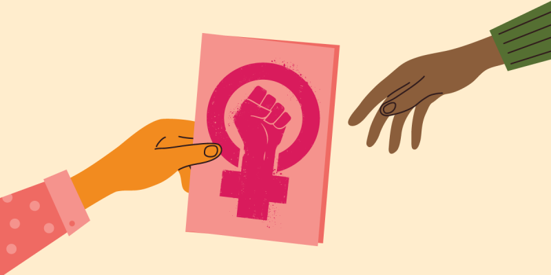 Two hands holding a placard that bears an insignia of feminist empowerment.